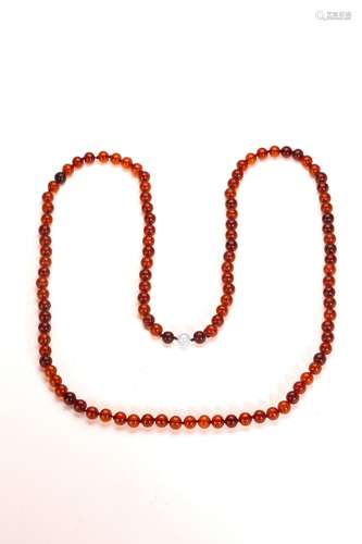 AN AMBER CARVED 108 BEAD BUDDHIST NECKLACE