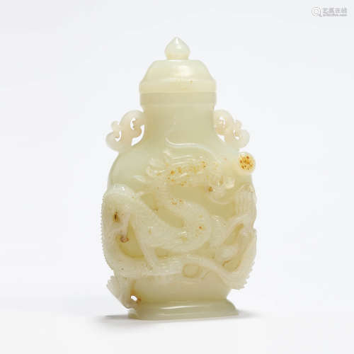 A carved white jade dragon vase with cover