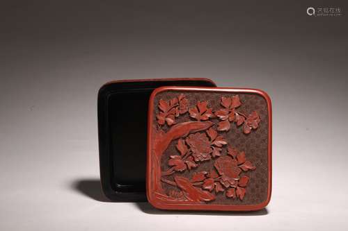 A CINNABAR LACQUER FLOWERS SQUARE BOX AND COVER