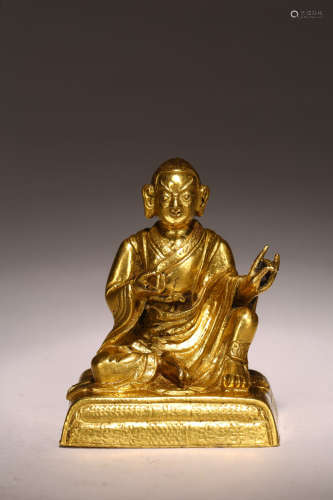 A GILT BRONZE FIGURE OF SEATED LAMA