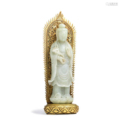 A carved white jade guanyin with gilt bronze halo
