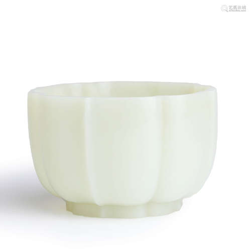 A carved white jade lotus-petal-shaped bowl