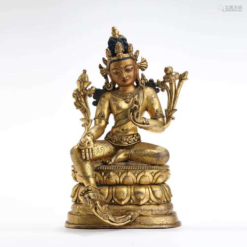 A gilt bronze seated statue of green tara