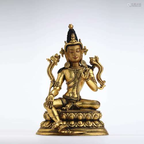 A gilt bronze seated statue of green tara