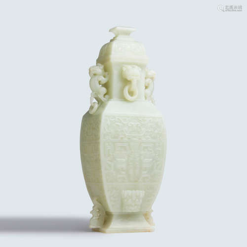 A carved white jade beast archaic vase and cover
