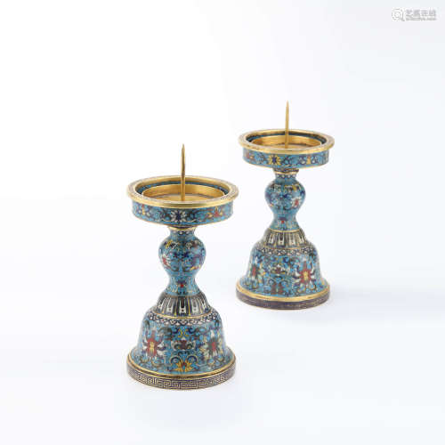 a pair of gilt bronze enamel interlocking lotus candlesticks