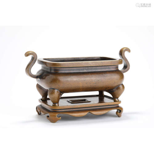 A bronze rectangular incense burner with stand