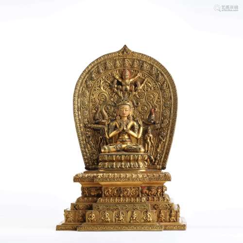 A gilt bronze seated statue of four-arm avalokitesvara