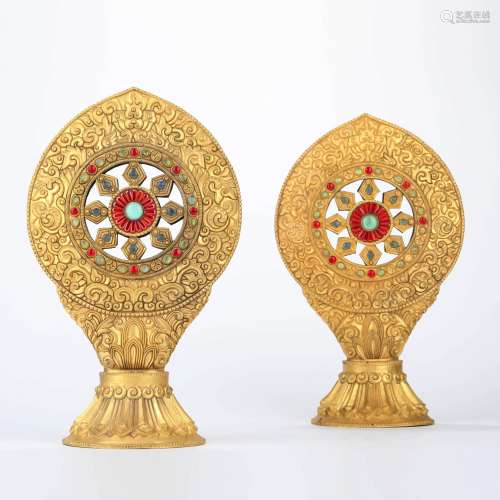 A pair of glass inlaid and gilt bronze buddhist wheels