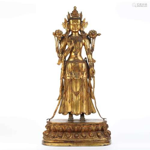 A gilt bronze standing buddha statue