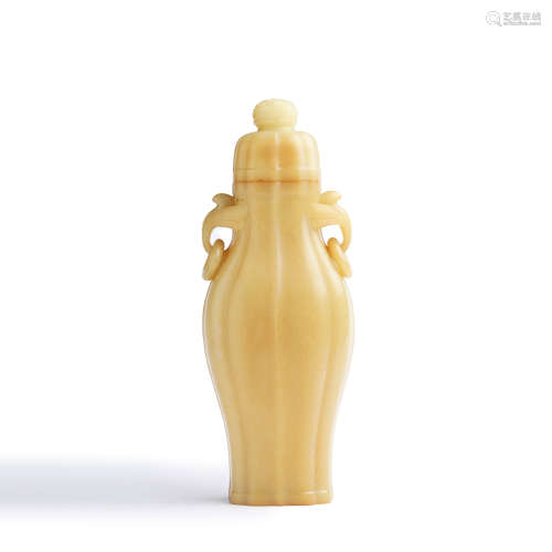 A carved yellow jade melon-shaped vase and cover