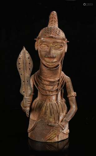 Benin bronze figure, Nigeria, 20th Century, of a warrior hol...