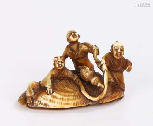 Japanese Meiji period Netsuke, carved with three figures clu...