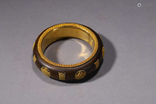 A Silver Gilding And Eaglewood Bangle