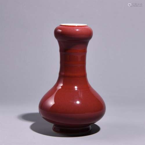 A RED GLAZED GARLIC SHAPED BOTTLE