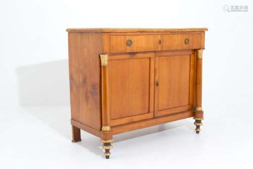 Wooden cupboard with golden finish. Empire style