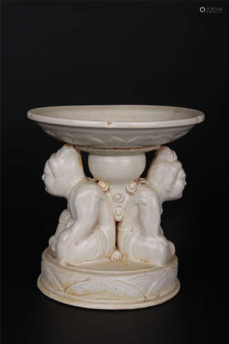 A DING WARE WHITE-GLAZE FIGURAL CANDLESTICK