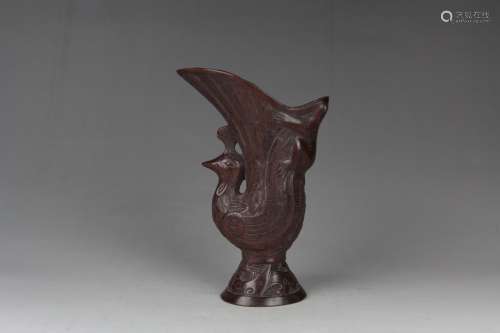 A CARVED ROSEWOOD PEACOCK RYHTON-FORM CUP