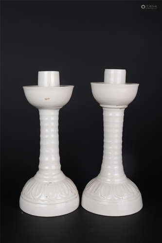 A PAIR OF DING WARE LOTUS-PETAL-FORM CANDLESTICKS