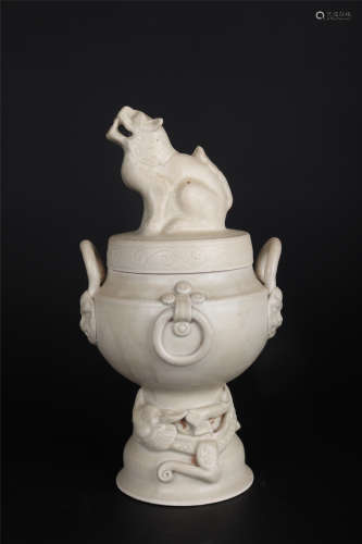A DING WARE WHITE GLAZE MYTHICAL BEAST INCENSE BURNER AND CO...