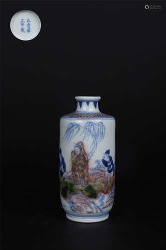 AN UNDERGLAZE-BLUE AND COPPER-RED GLAZE FIGURAL SLEEVE VASE