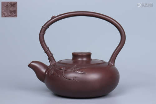 A PURPLE CLAY LOOP-HANDLE TEAPOT