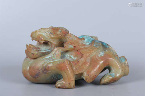 A CELADON AND RUSSET JADE CARVING OF A BEAST