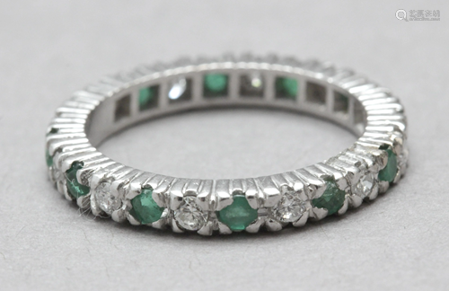 A brilliant cut diamonds and emeralds eternity ring