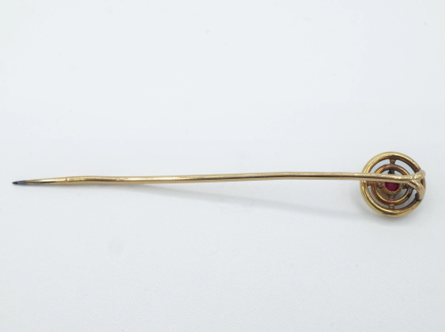 A mid 20th century gold and garnet tie pin