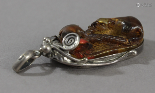 A19th century Japanese amber and silver pendant form