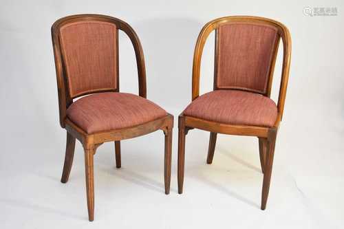 A set of four French stripped walnut side chairs upholstered...