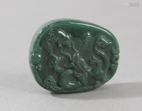 An early 20th century Chinese pendant in carved green