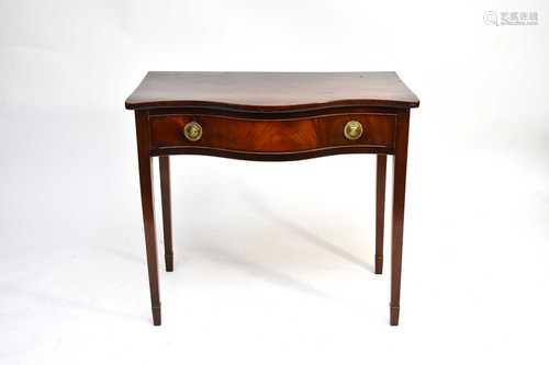 A George III mahogany serpentine side table