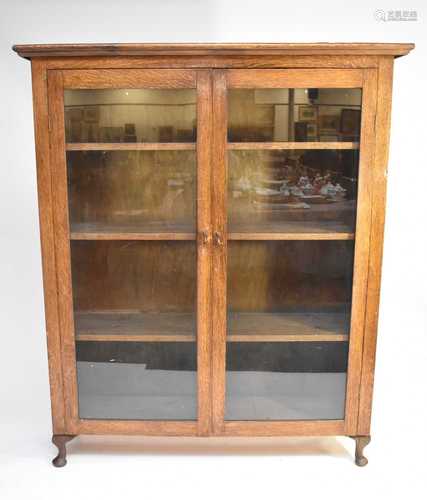 A mid-20th century oak glazed bookcase