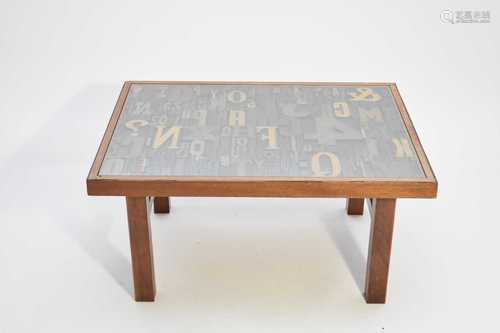 A contemporary teak and mixed wood coffee table