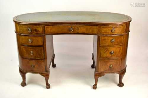 A 20th century mahogany kidney-shaped desk