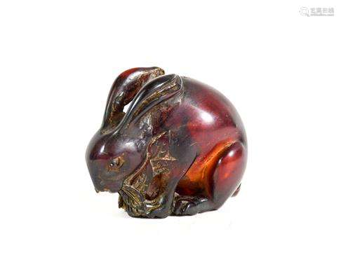 A Japanese Amber Netsuke, Meiji period, naturalistically car...