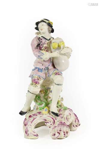 A Bow Porcelain Figure of a Bagpiper, circa 1765, seated on ...