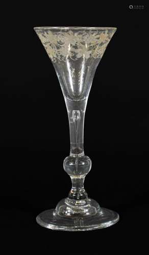 A Wine Glass, 1740, the drawn trumpet bowl engraved with fru...