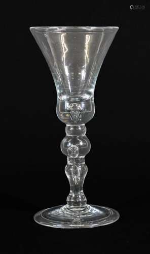 A Wine Glass, circa 1730, the thistle shaped bowl with air t...