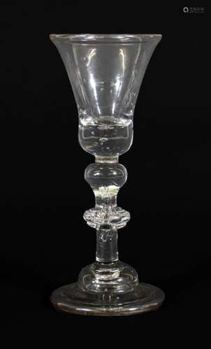 A Wine Glass, circa 1730, the bell shaped bowl with air tear...