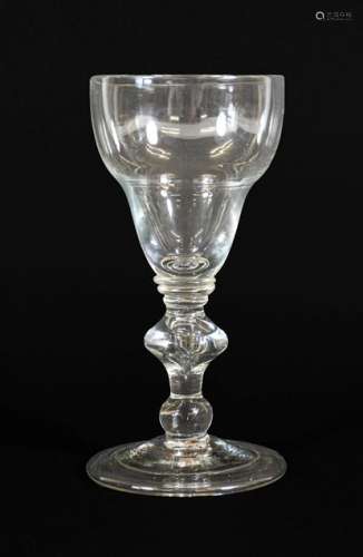 A Large Wine Glass, circa 1710, the ogee bowl on triple coll...