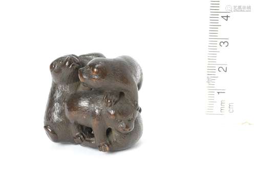 A wood netsuke of five puppies By Yukisada, 19th century