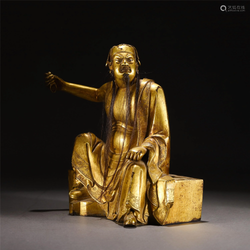 A CHINESE GILT BRONZE SEATED FIGURINE OF GUAN-GONG