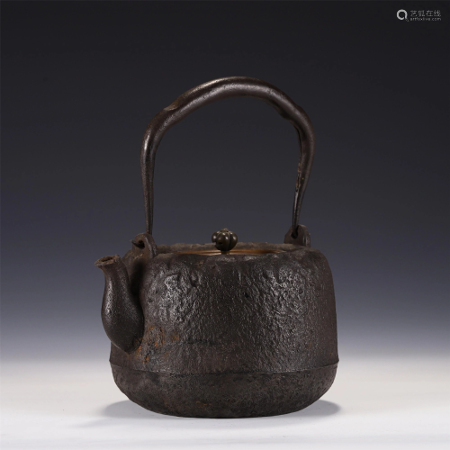 A CHINESE IRON POT WITH A LOOP HANDLE