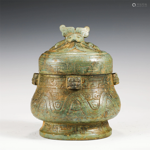 A CHINESE BRONZE COVERED JAR WITH BEAST HANDLES