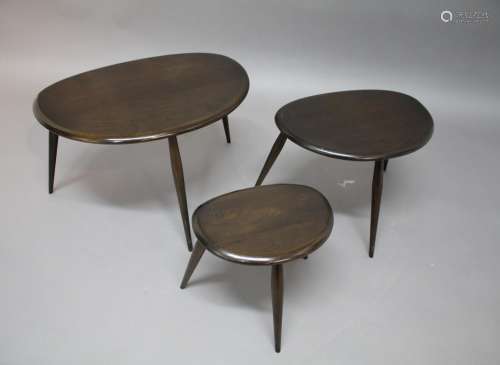 ERCOL 'PEBBLE' NEST OF TABLES a set of three dark elm tables...