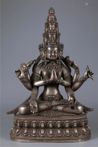 A SILVER EIGHT-ARM AND ELEVEN-FACE BUDDHA STATUE