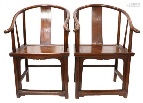 Pair of 20th century Chinese stained elm horseshoe back armc...