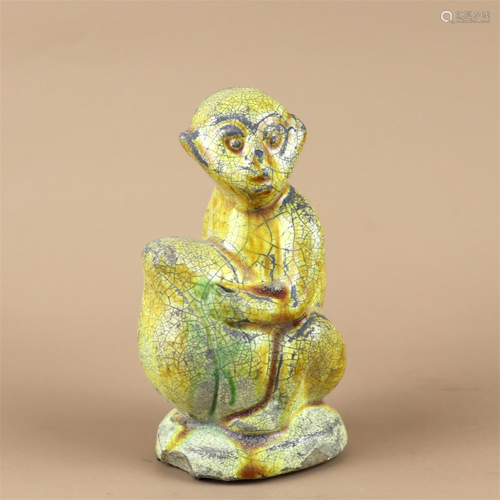 A Yellow Glazed Porcelain Monkey Shaped Ornament